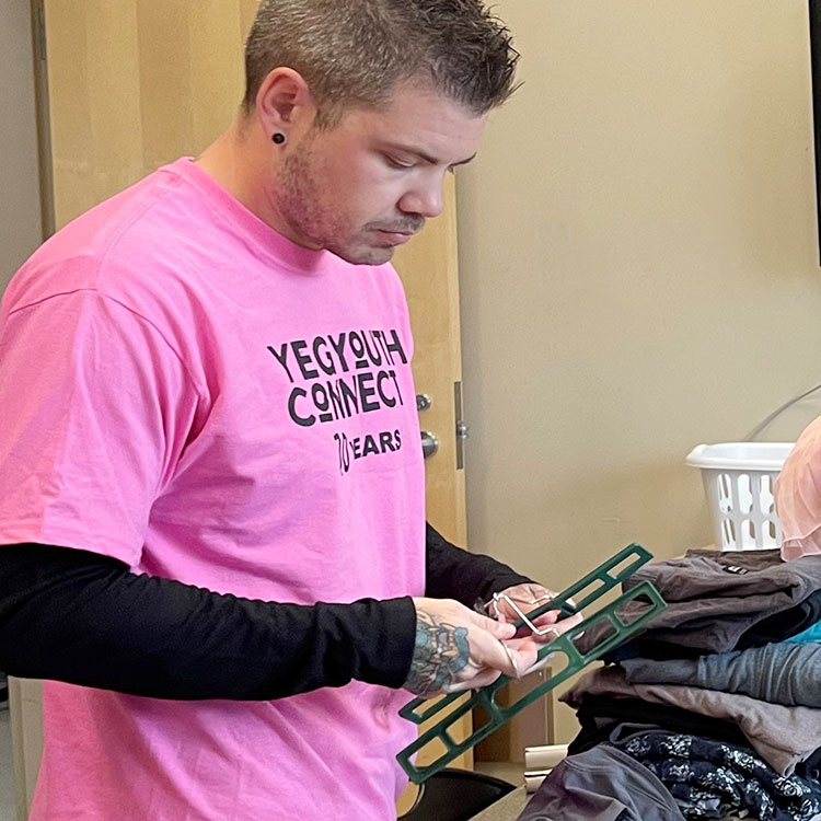 A TNPI employee helps set up for the YEG Youth Connect event in Edmonton.