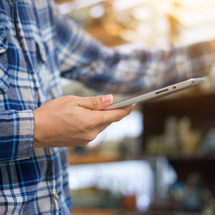 close up of han holding a tablet electronic device