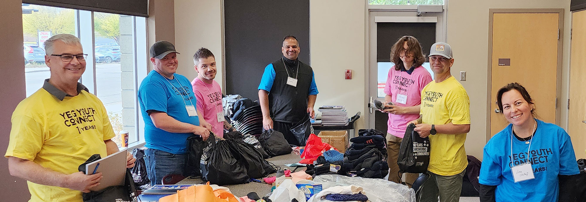 A group of employees and other volunteers prepare packages for attendees of the YEG Youth Connect event in Edmonton.